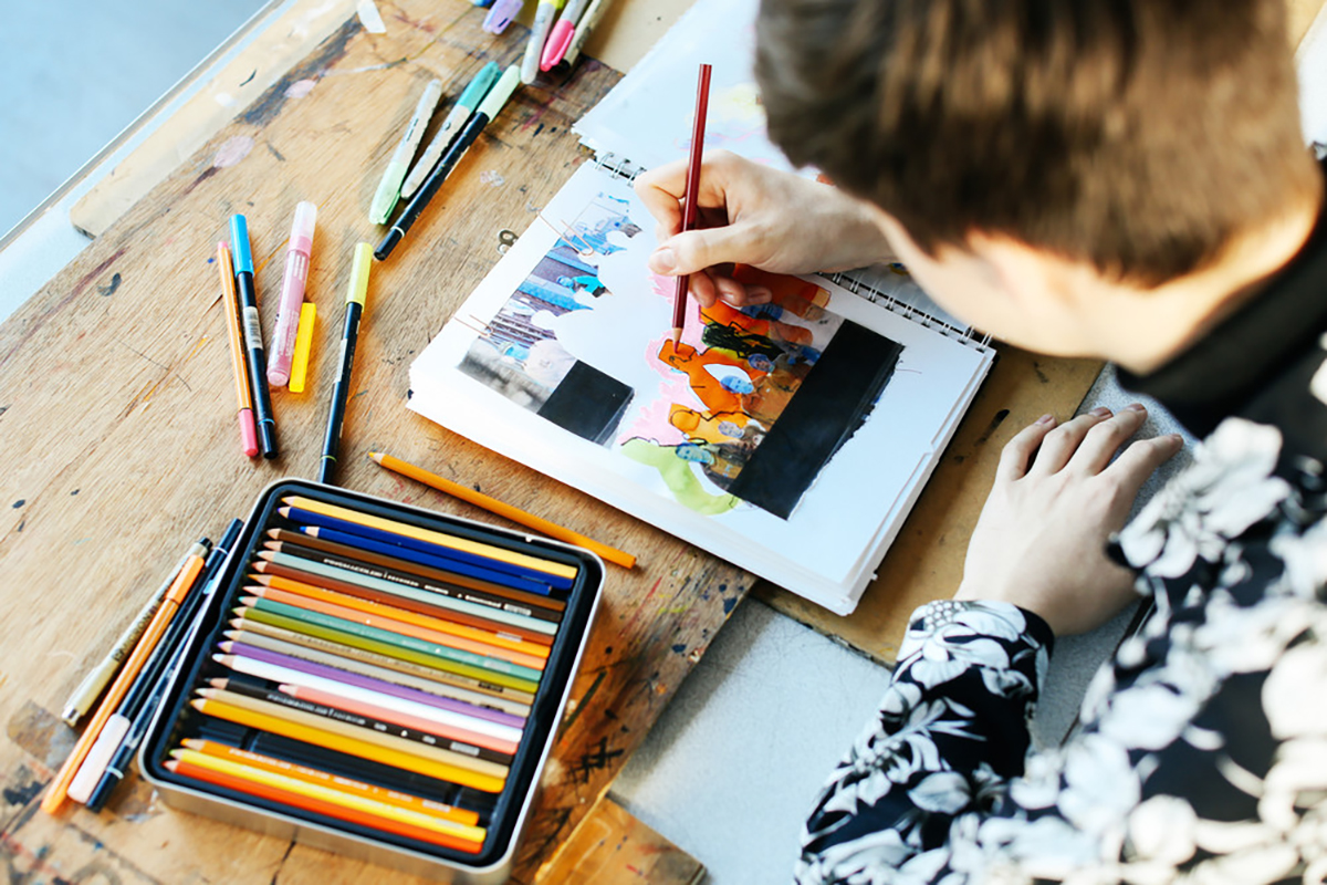 Student working on illustration using colourful pens