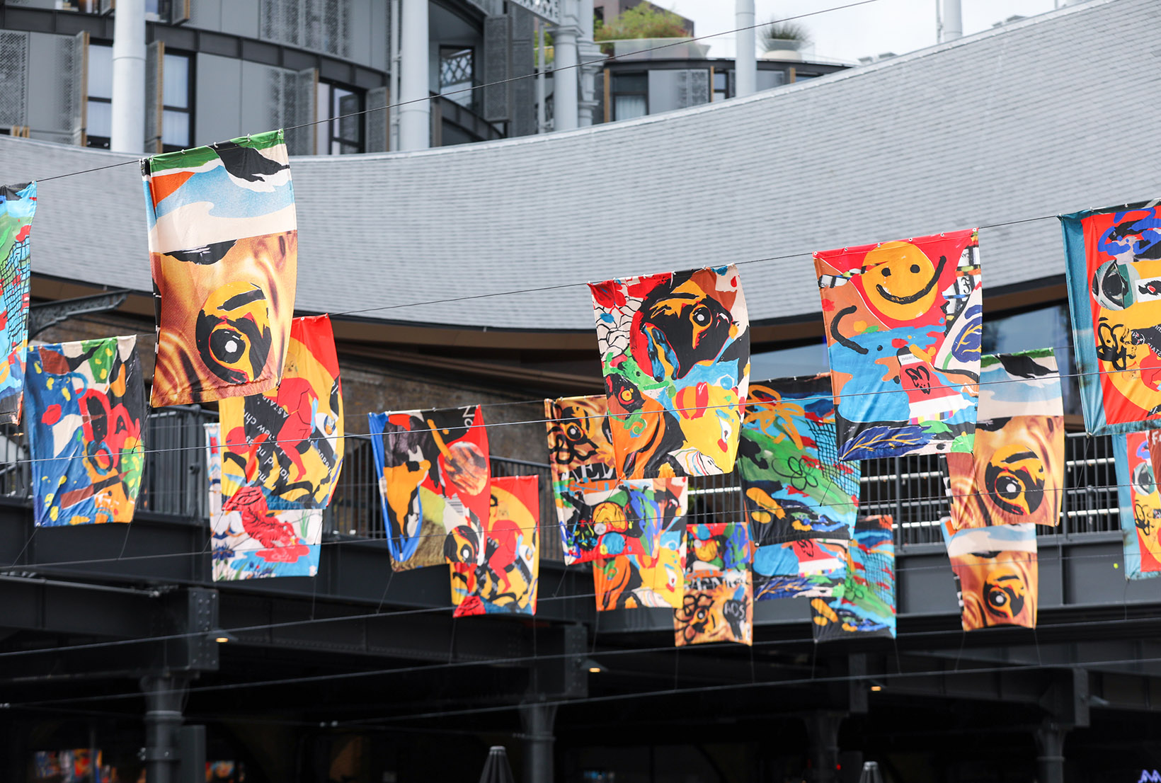 Raised, coloured flags with a mix of red, yellow and black curved patterns.
