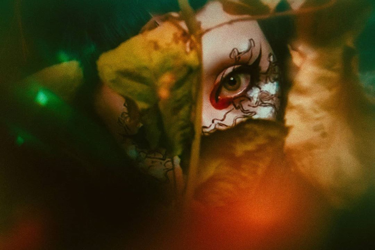 Image of woman looking straight at the camera wearing fantasy makeup