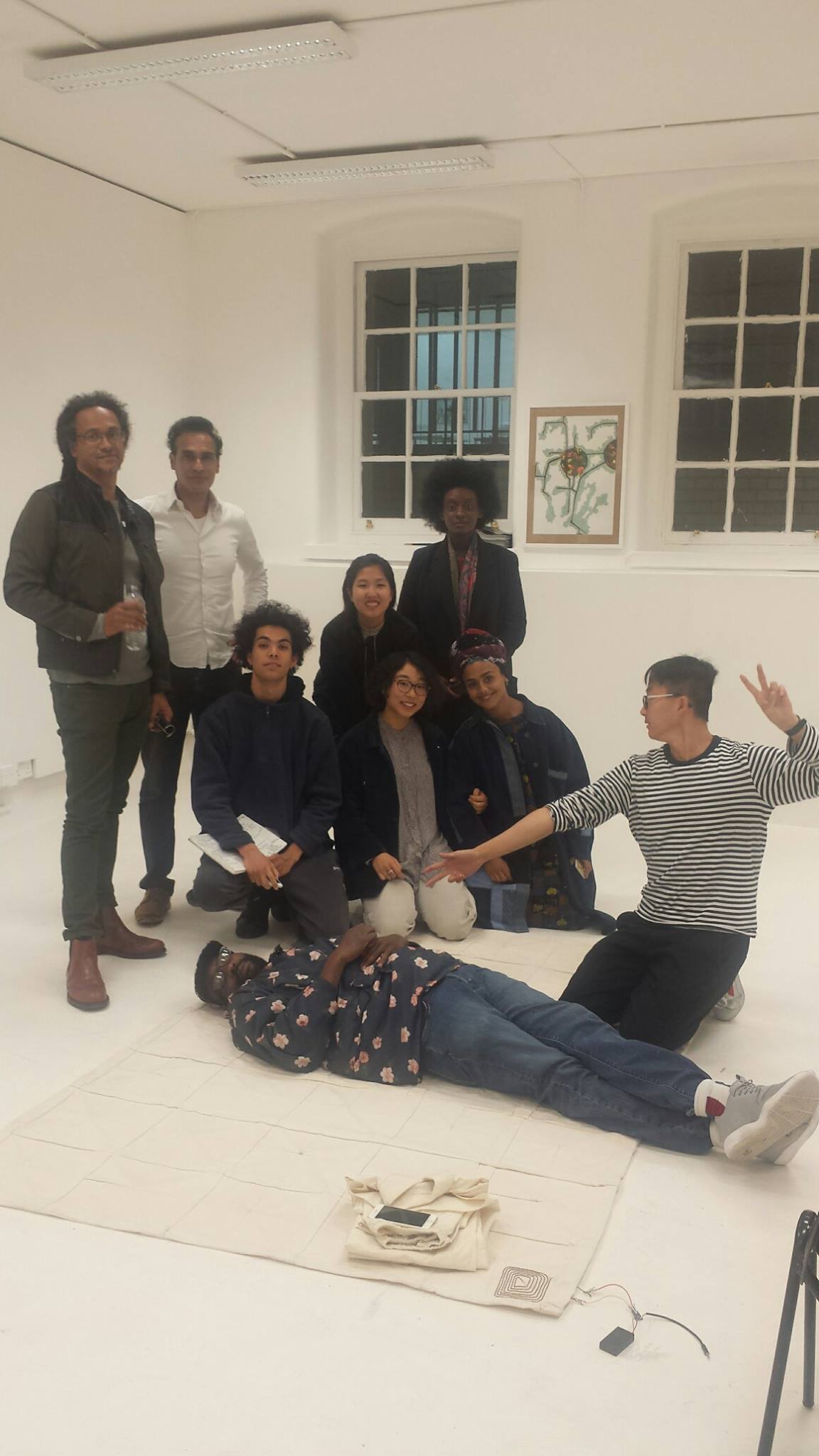 The group relaxing at the crit of the Beginnings of Truth exhibition with Dr Kimathi Donkor (far left).