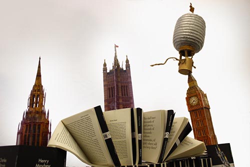 Close-up view of “They take us from a balloon ride over Victorian London to a garden of blossom in Japan” by Alex Wood. Paper, card, bronze powder, twine, and Penguin Little Black Classics, 2015