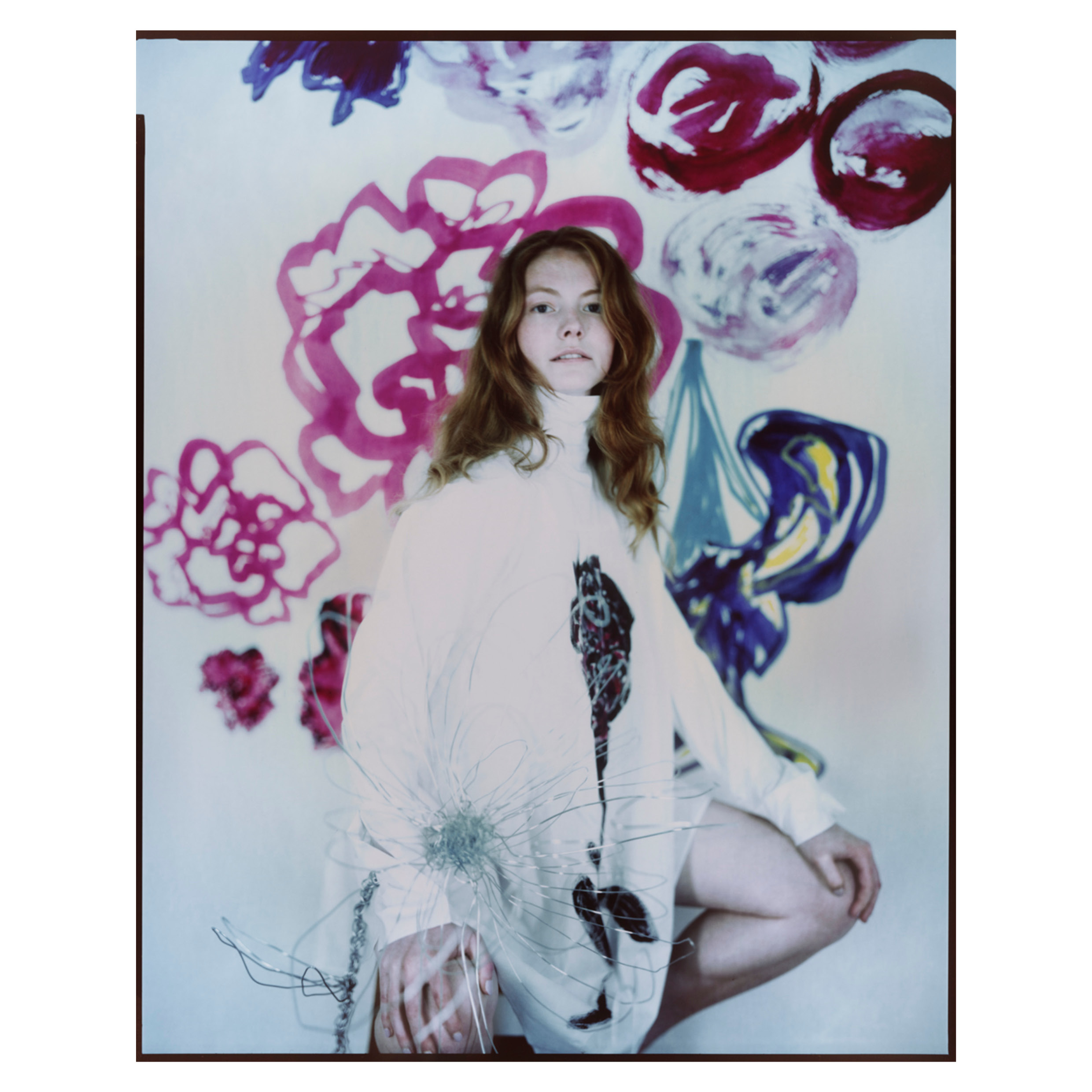 Model posed in front of printed fabric