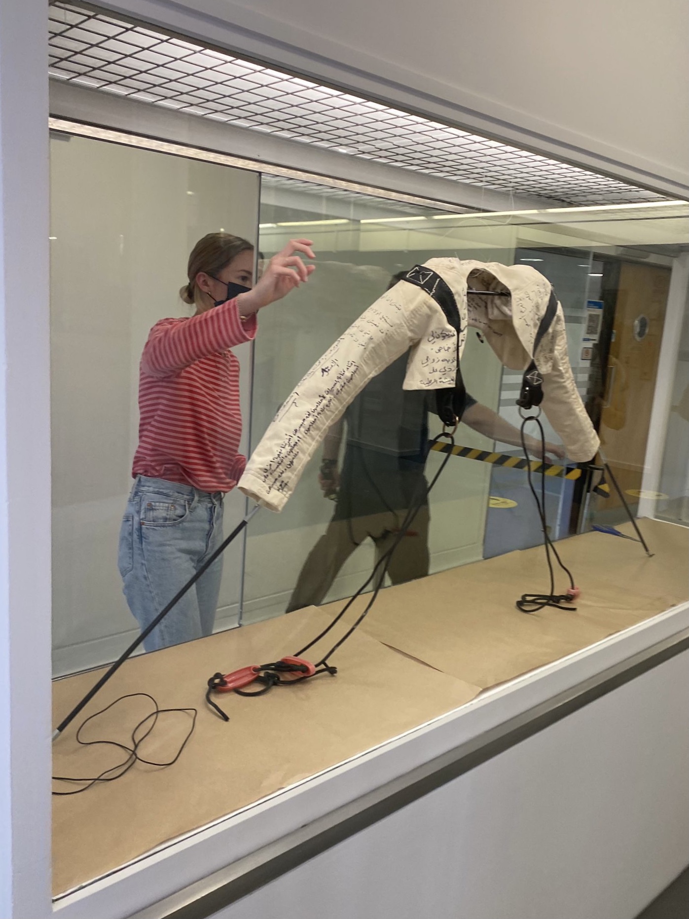 student installing display in vitrine