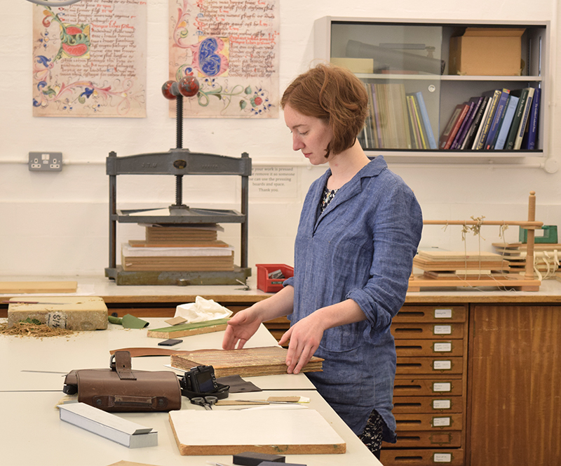 MA Conservation student Nikki Thompkins working on a Heraldic manuscript