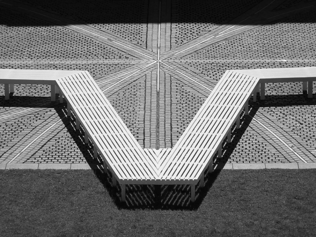 View of Pentagon Petal by artist Fran Cottell and architect Marianne Mueller, an art installation at Chelsea College of Arts, UAL which is open to the public until 30 July 2016. This project on the on the Rootstein Hopkins Parade Ground re-enacts a scaled version of Millbank Prison's plan, editing and reinterpreting it into a more socially active figure: a 120m long flower shaped bench.
