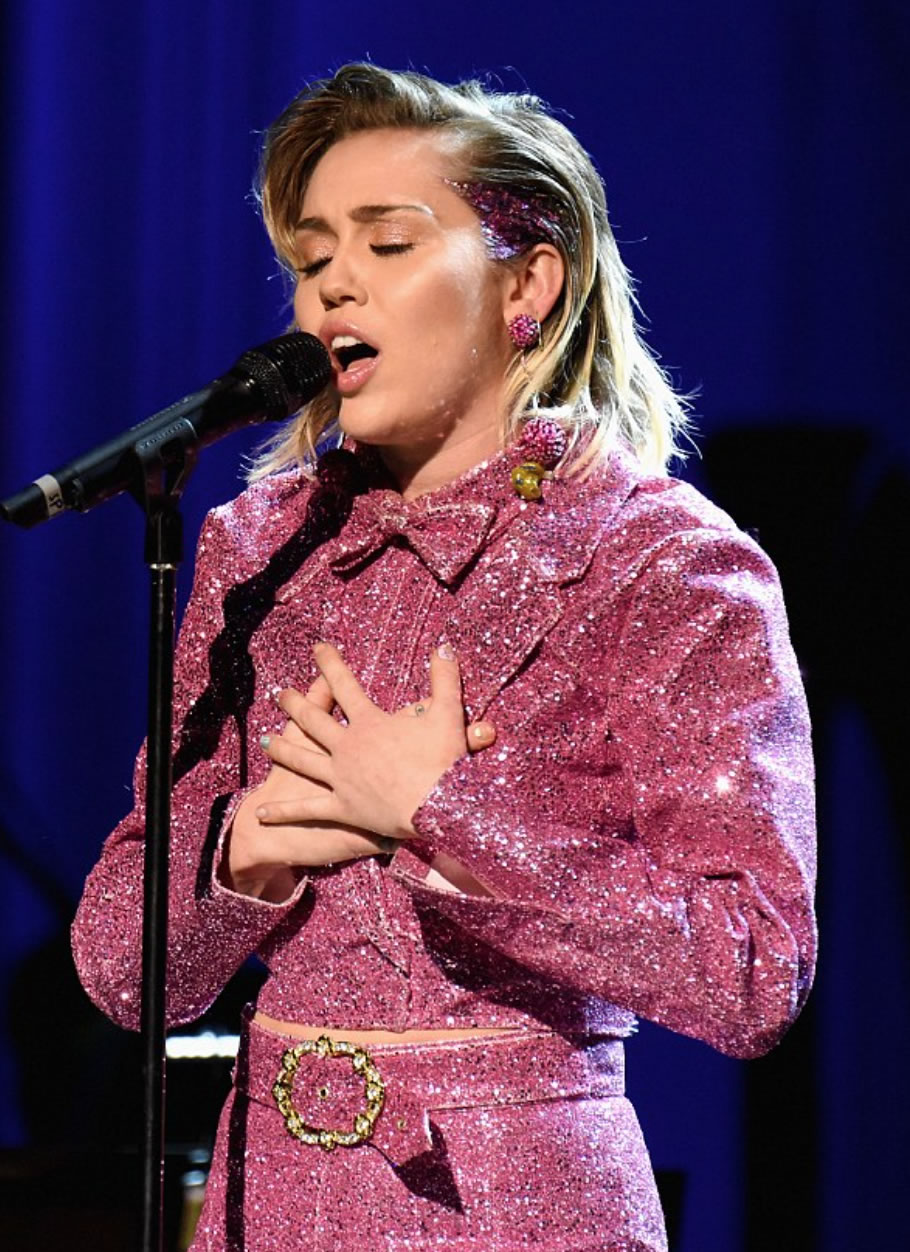 Miley wears full pink glitter tux from Christian's AW14 collection 'Girls Like Us'. Also seen on Lady Gaga