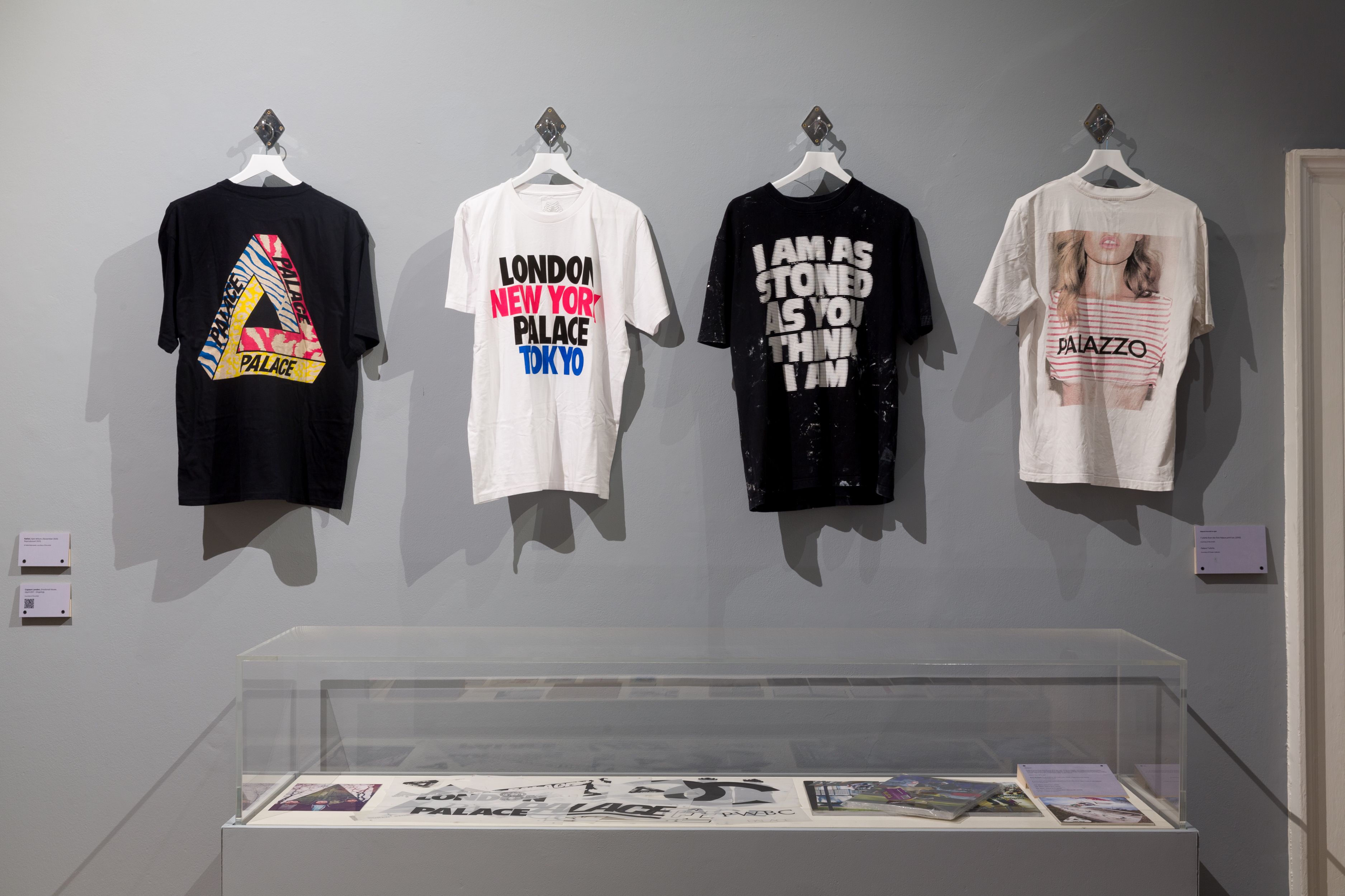 t shirts with slogans mounted on wall