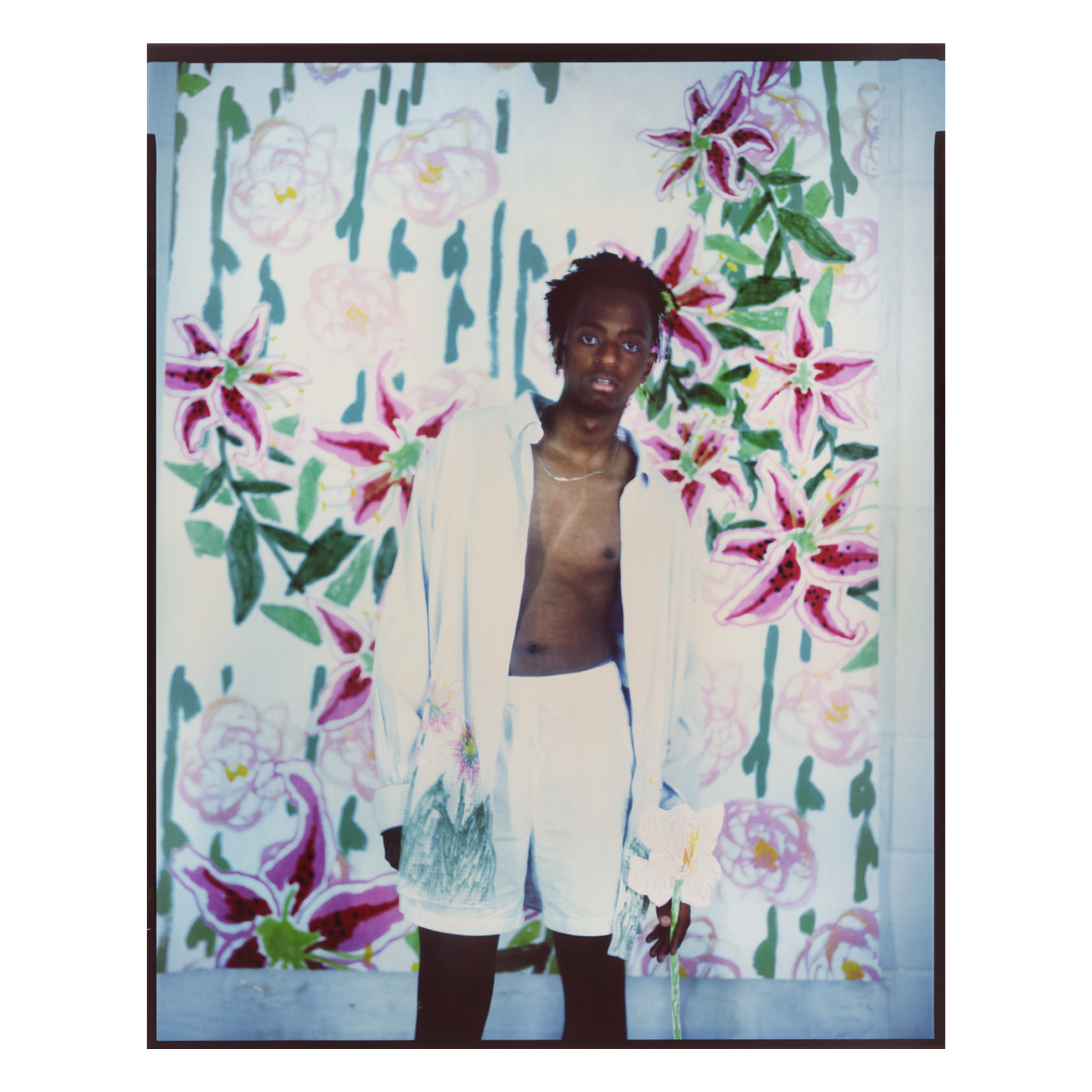 Model posed in front of printed fabric