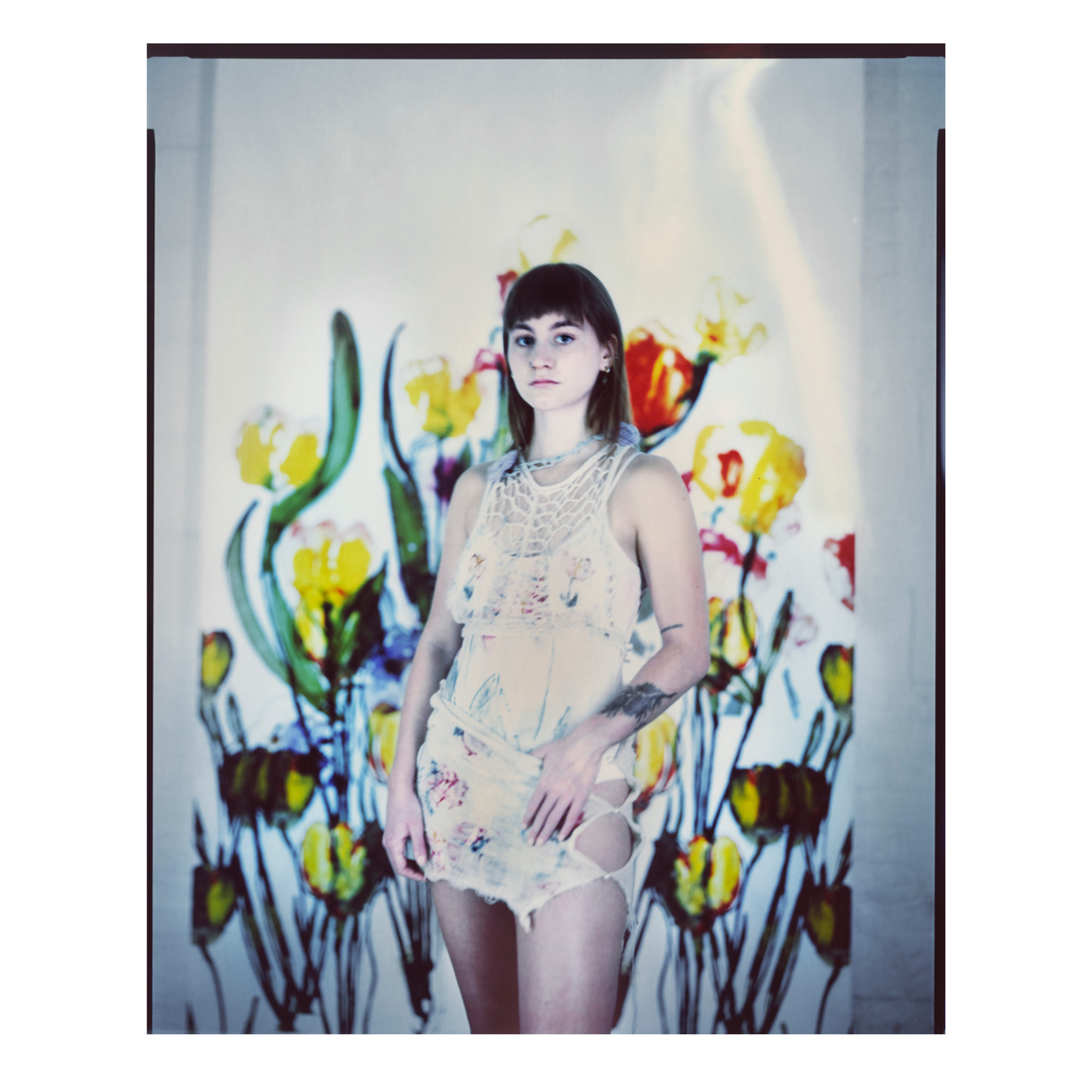 Model posed in front of printed fabric