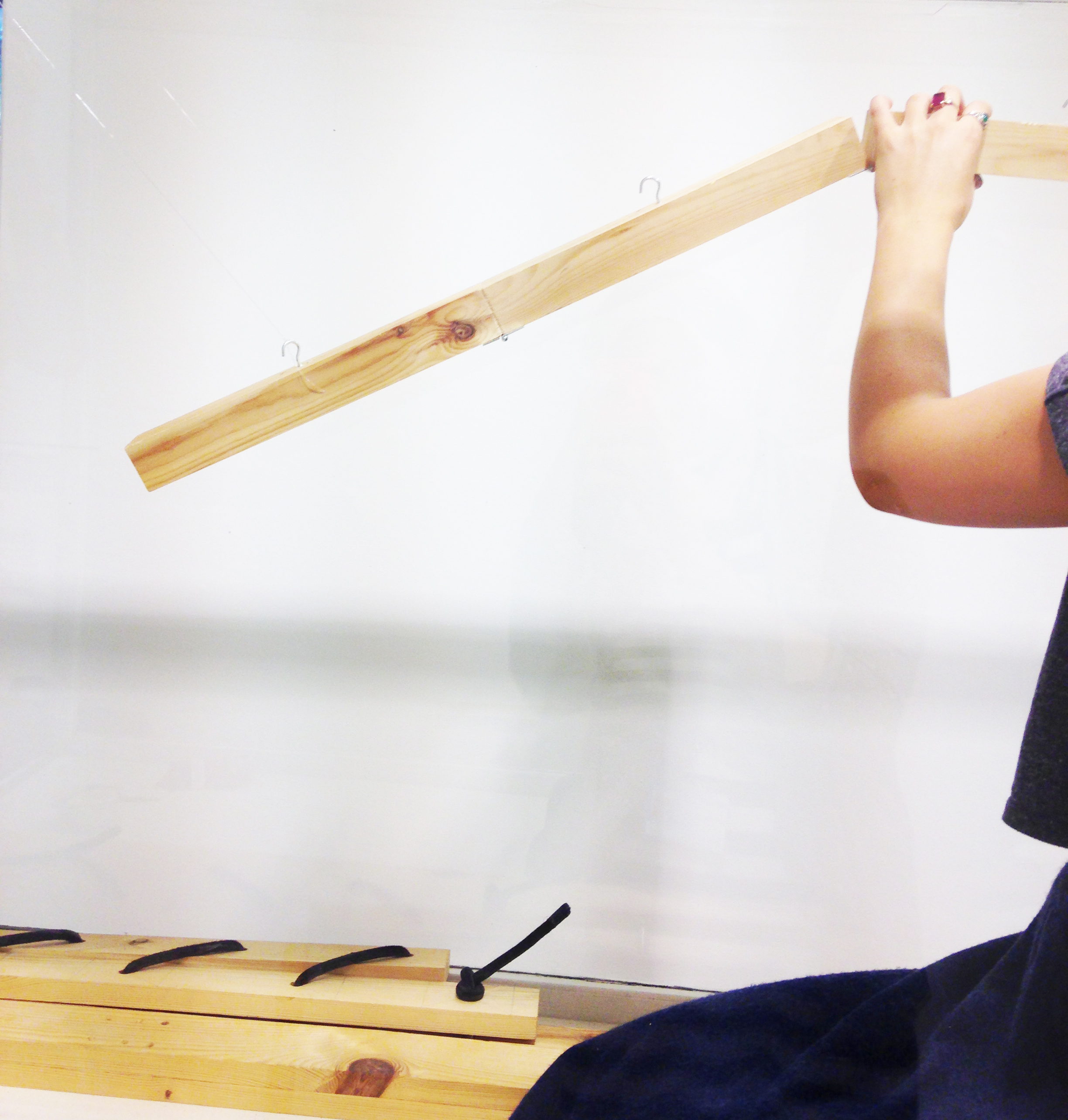 Hanging the wooden arm in one of the exhibition cases