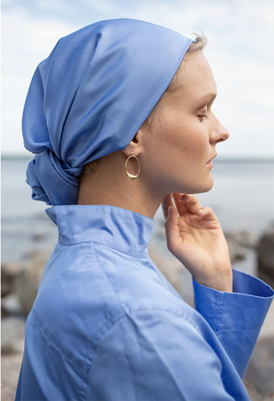 Woman wearing blue headscarf and blue blouse