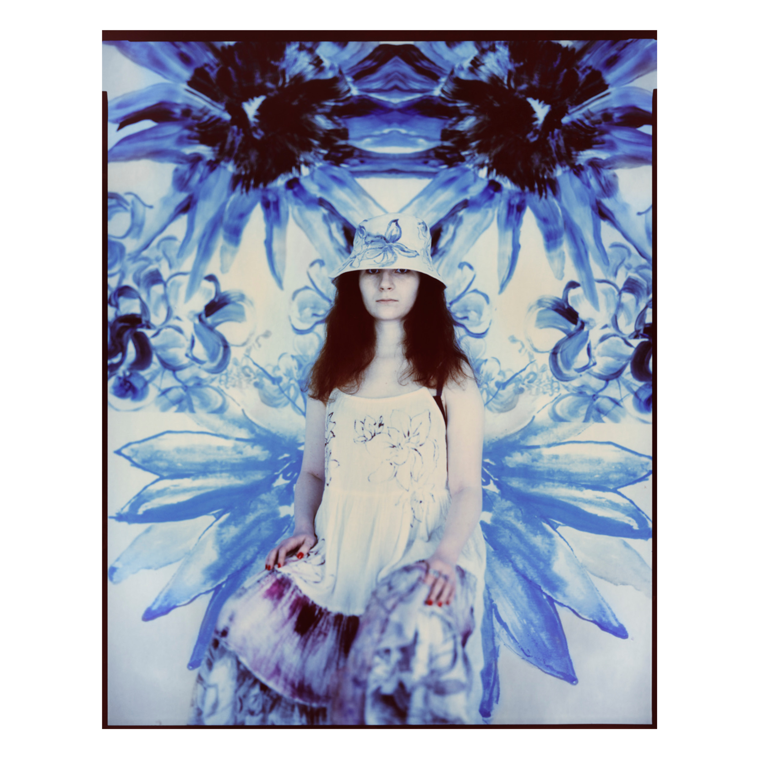 Model posed in front of printed fabric