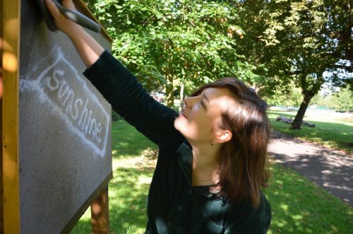 Alice Cretney installing artwork 'Sunshine' by artist Sam Cotterell for 'Fungus Press' poster project in Croydon's public realm, 2015