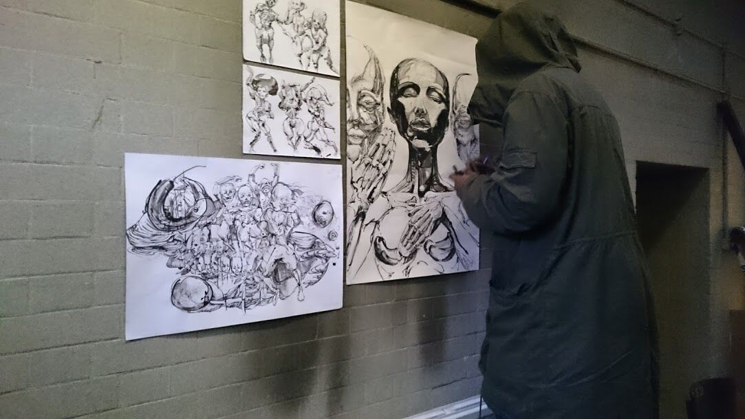 BA Drawing students external exhibition at Hotel Elephant. Image of student creating detailed black and white portraits for exhibiton