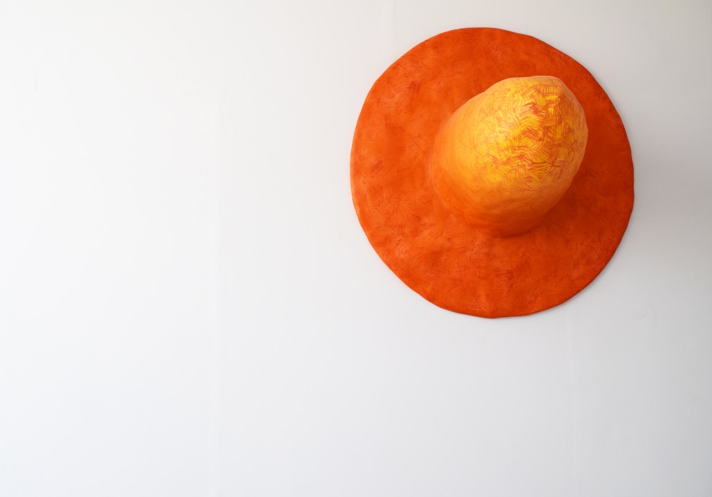 Large scale cast orange Fedora hat hanging on wall Hamish Pearch (BA Sculpture 2015)