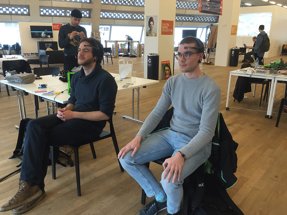 Visitors playing the Mental Arm Wrestle at Tate Exchange