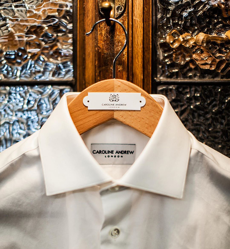 White blouse hanging on wooden hanger