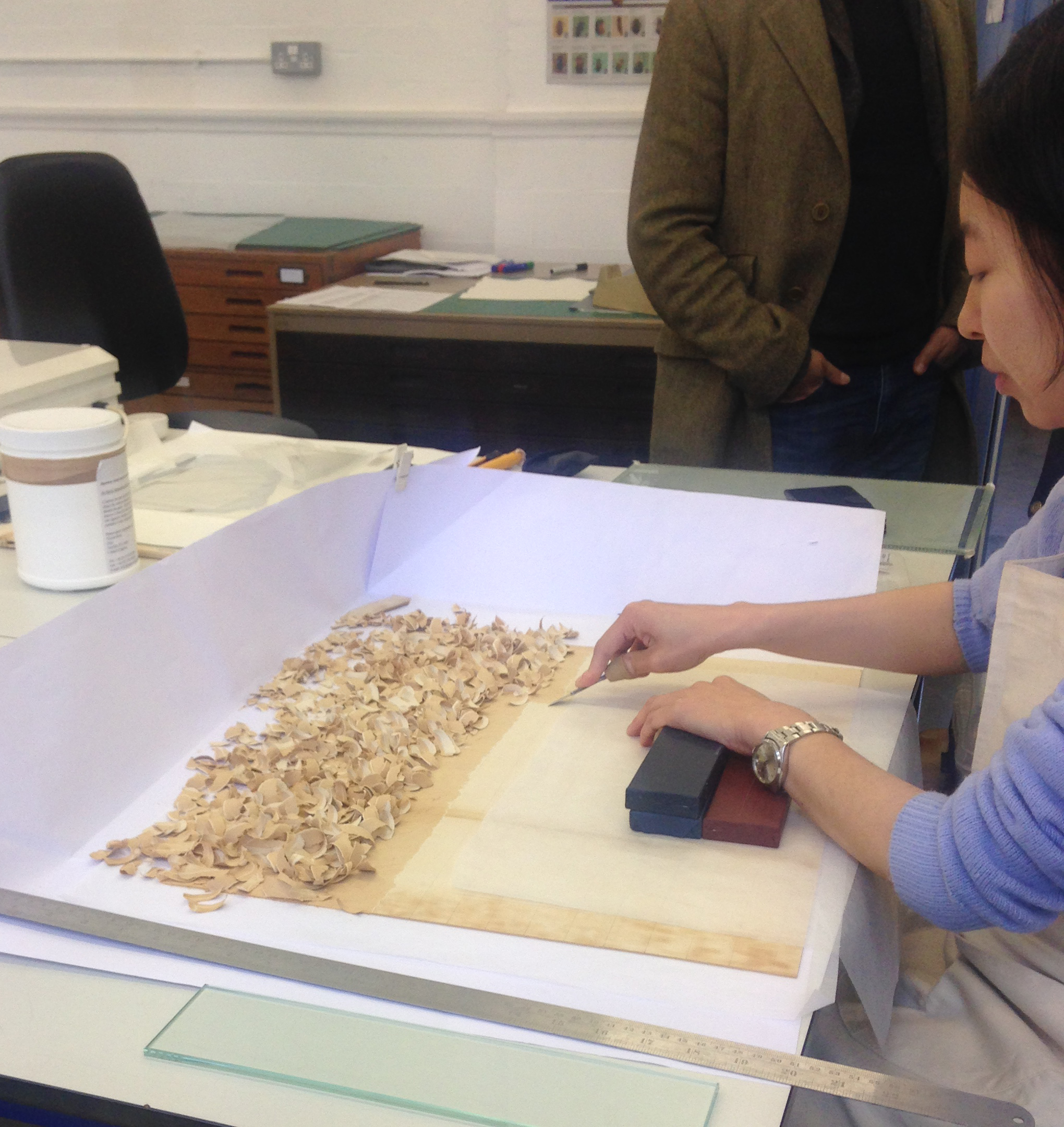 Student Cathy, removing the current backing from a Royal Botanical Garden, Kew piece 