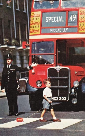 Boy walks with little bus