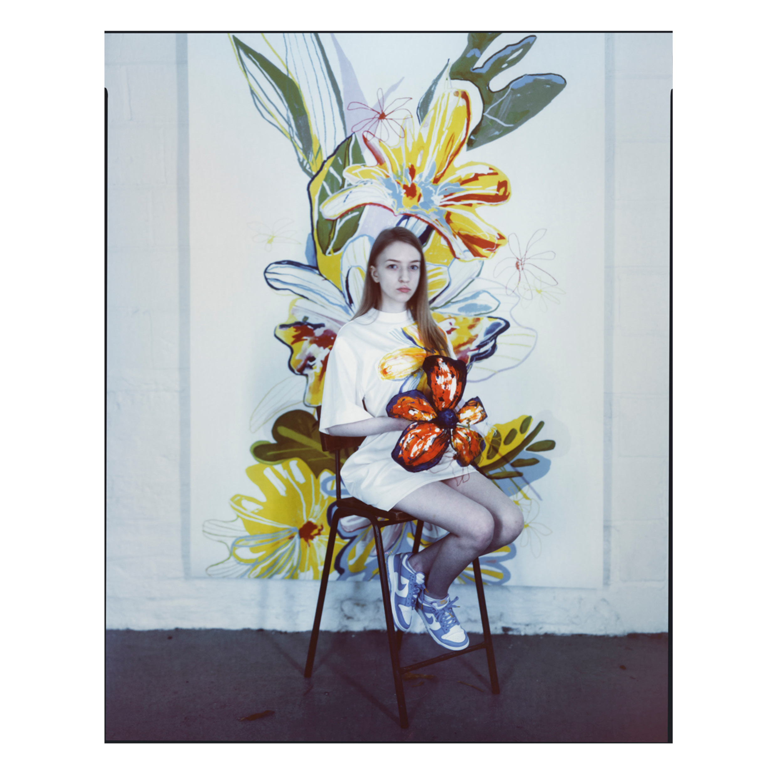 Model posed in front of printed fabric