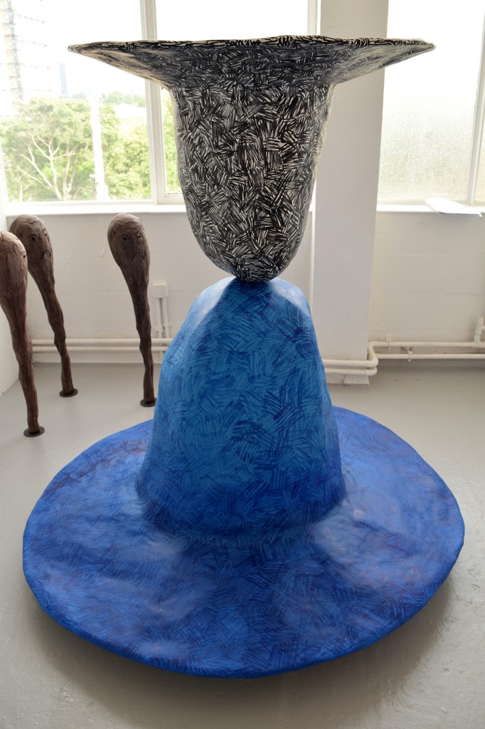 Two large scale cast Fedora hats resting on top of one another one blue, one black Hamish Pearch (BA Sculpture 2015)
