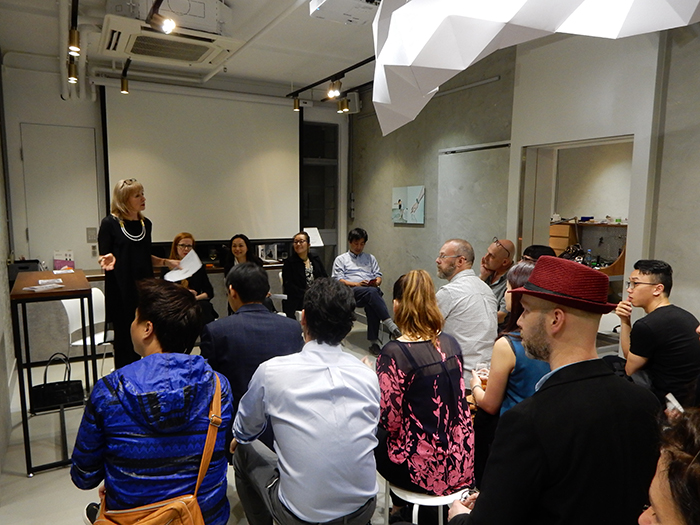 Panel of speakers in front of audience