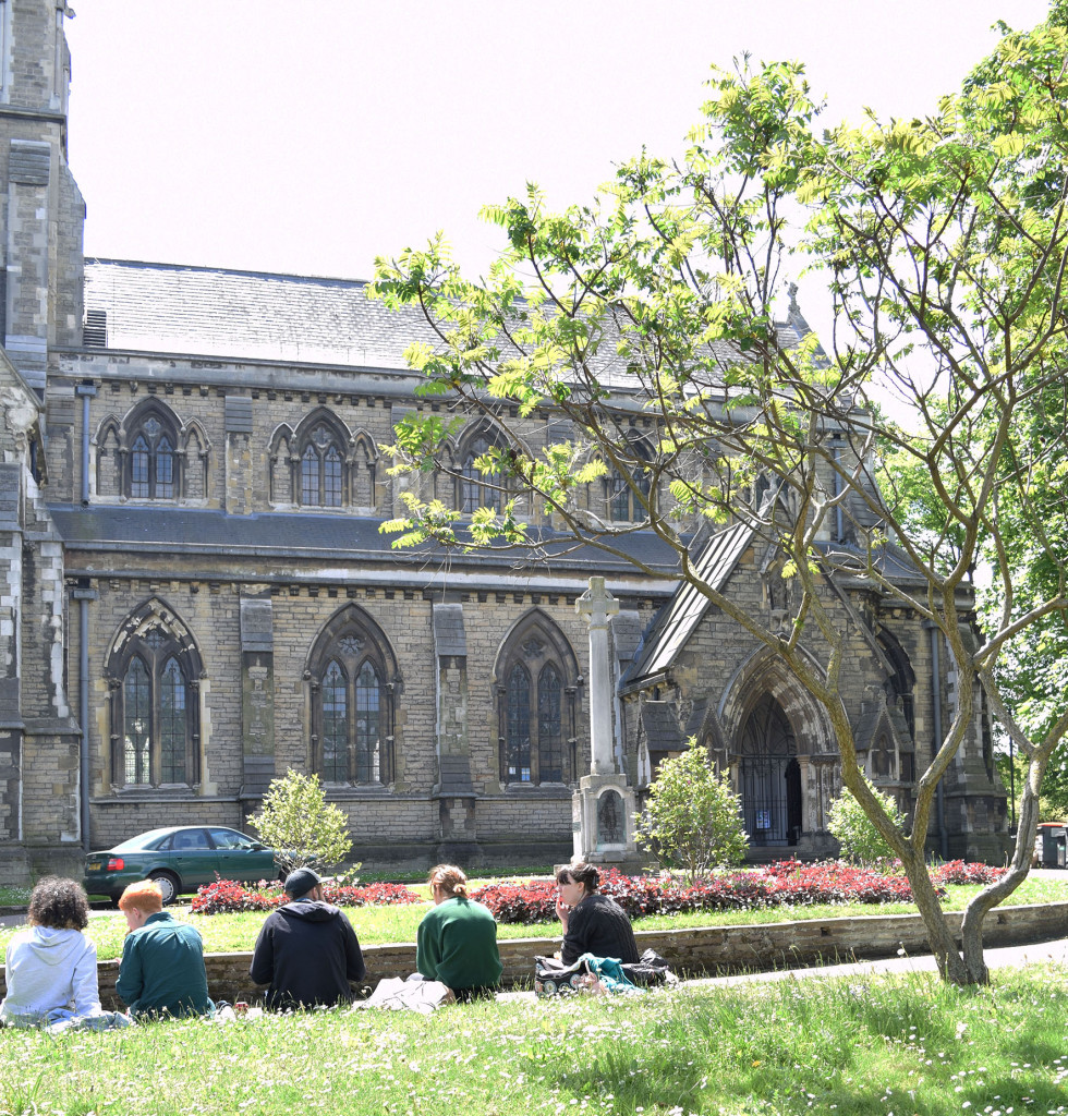 Photograph of students relaxing outside St Giles Church