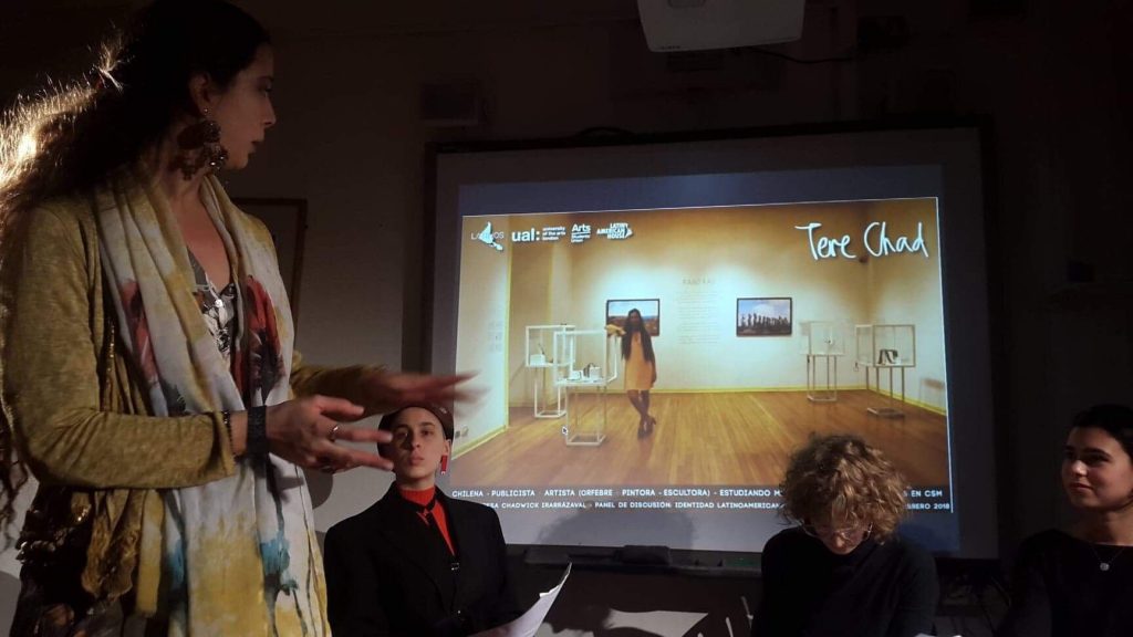 A woman presents in front of a screen