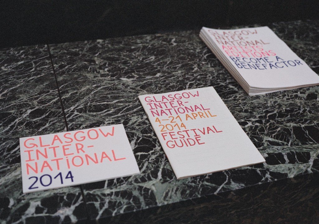 Guides to Glasgow International, three guides printed in Red and Blue on top of a marble surface 