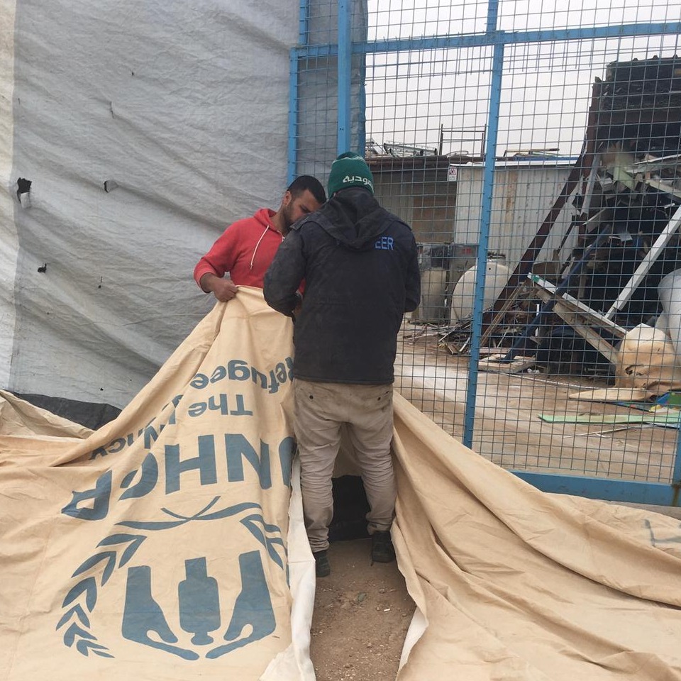 UN tent being torn in 2 by men