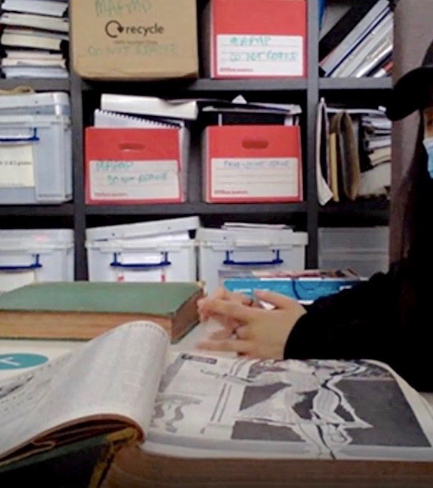 person working in archive with boxes