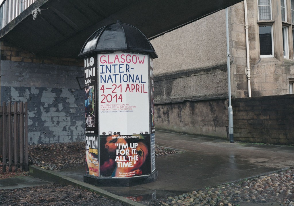 Big poster promoting Glasgow International festival printed on white paper with red and blue ink 