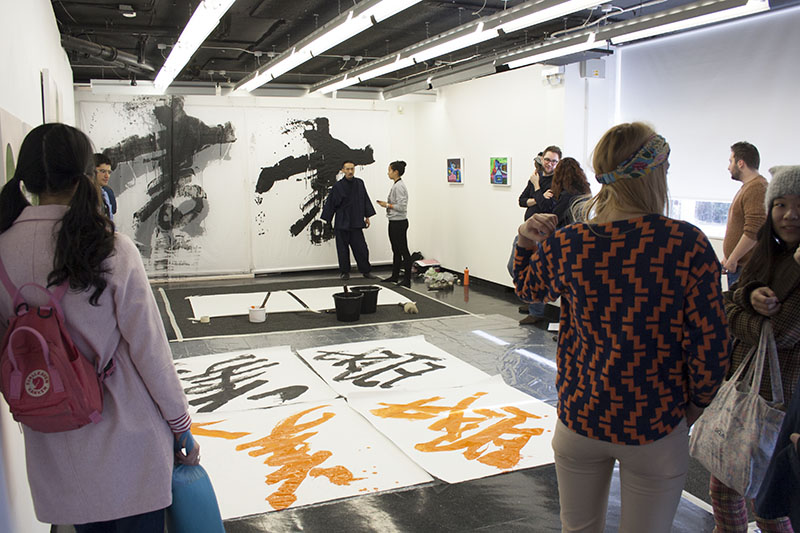 Group of Postgraduate Community students observing the calligraphy workshop