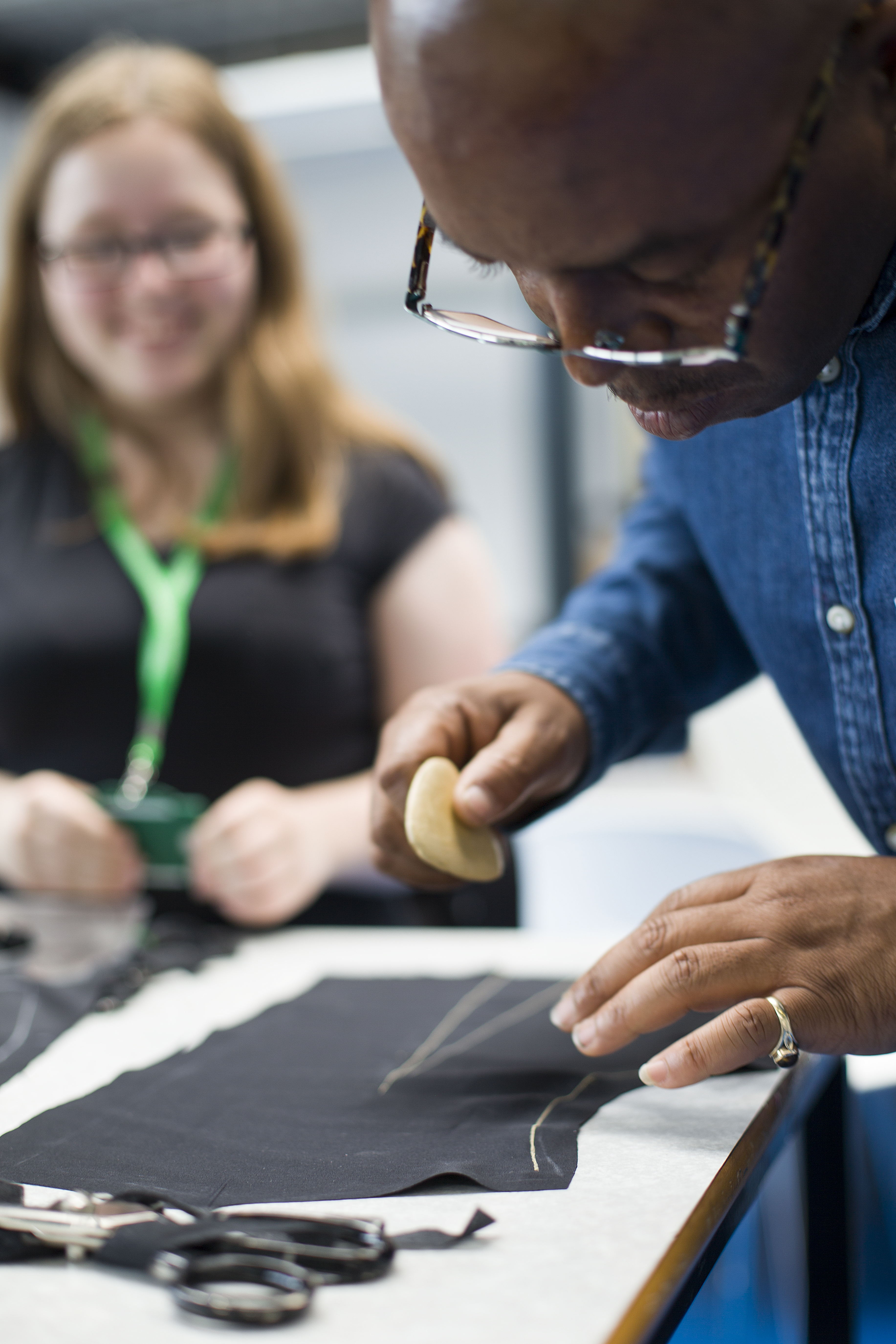Winston Rose teaching the college students tailoring skills
