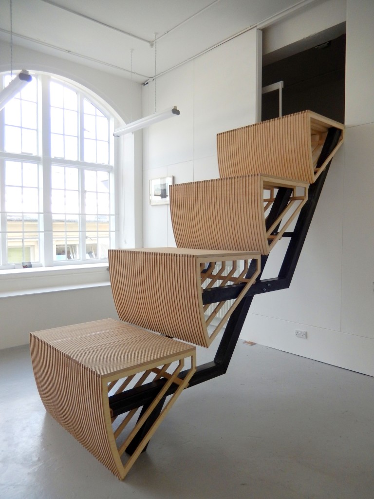 Image of large sculpture. Wooden escalator steps leading up to the ceiling of one of Camberwell's Painting studios