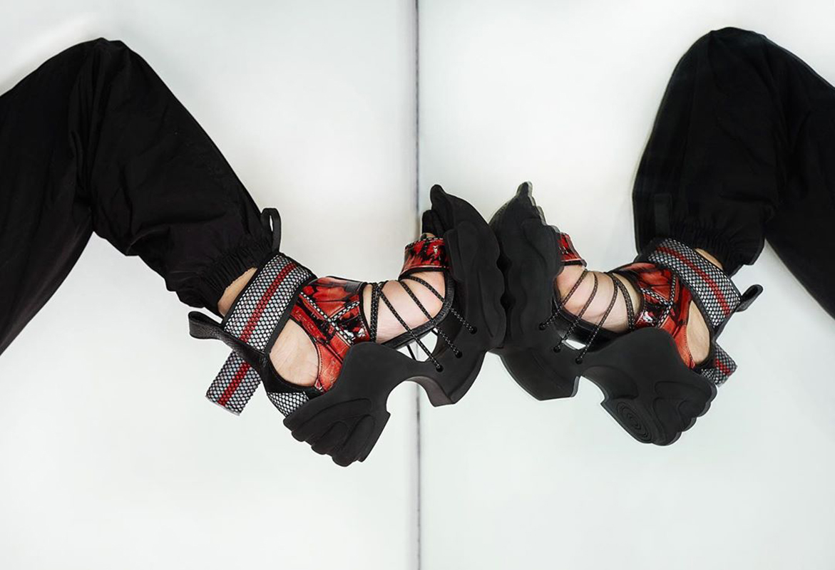 Female model wearing black and red sandals