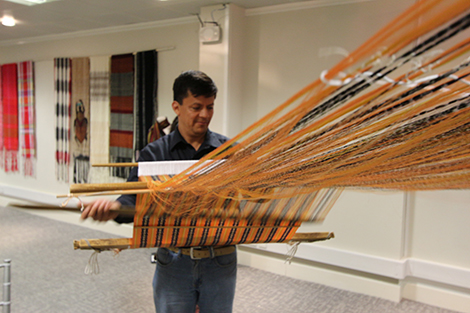 A man using traditional 'backstrap weaving' techniques to create a rebozo at the opening of the exhibition. Photography by Gavin Freeborn.