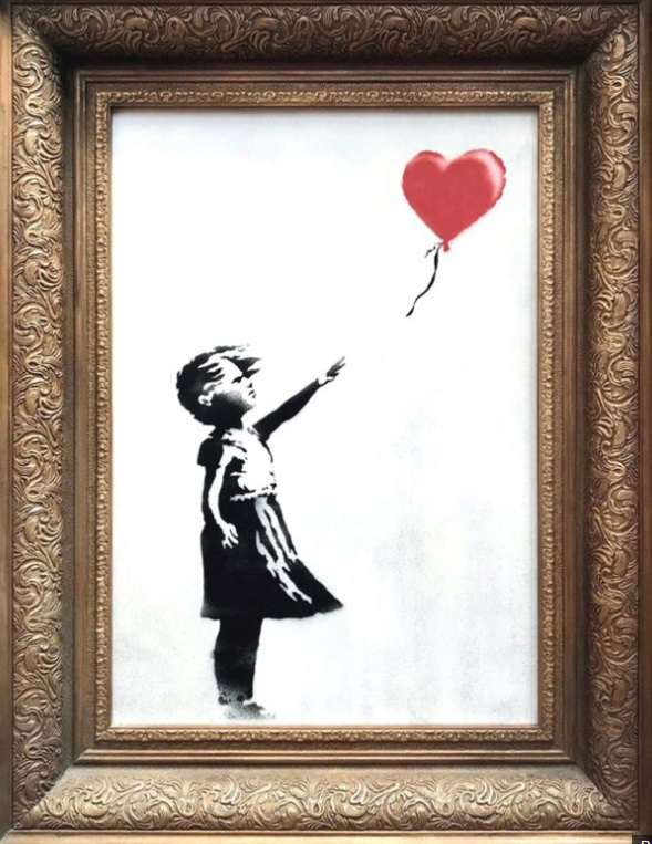 A print of a girl releasing a heart shaped balloon