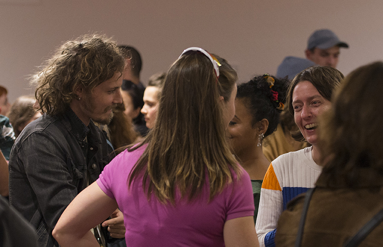 students and staff chat over drinks