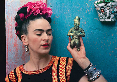 Frida Kahlo with Olmec figurine, 1939. Photograph by Nickolas Muray
