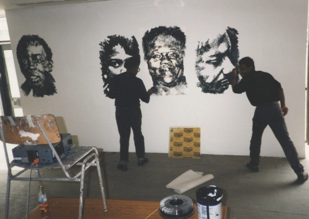 Keith Piper and Donald Rodney setting up for first ever for a London arts college black artists only exhibition - The Devils Feast Exhibition in 1987 at Chelsea College of Art